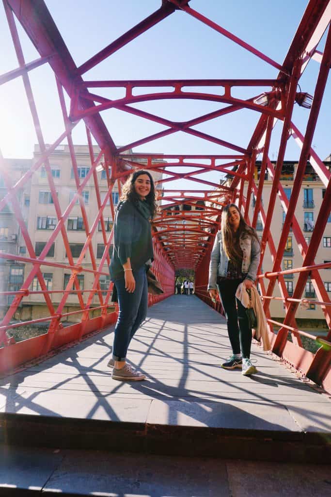 1. Walk across the Eiffel Bridge Girona's jewel is the Eiffel bridge, which although it was designed by the same Gustave Eiffel as Paris' Eiffel Tower, with a similar aesthetic, is understated just like the rest of the city. TripAdvisor seems to bash it for its humble appearance, but I loved the Eiffel Bridge's simplicity. As you walk across, make sure you get a quintessential photo looking at the colorful houses along the river Onyar through the bridge's steel work!