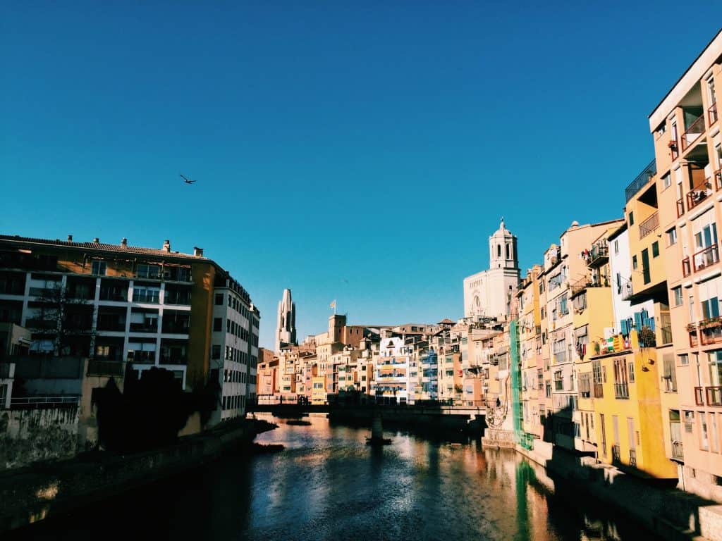 1. Walk across the Eiffel Bridge Girona's jewel is the Eiffel bridge, which although it was designed by the same Gustave Eiffel as Paris' Eiffel Tower, with a similar aesthetic, is understated just like the rest of the city. TripAdvisor seems to bash it for its humble appearance, but I loved the Eiffel Bridge's simplicity. As you walk across, make sure you get a quintessential photo looking at the colorful houses along the river Onyar through the bridge's steel work!