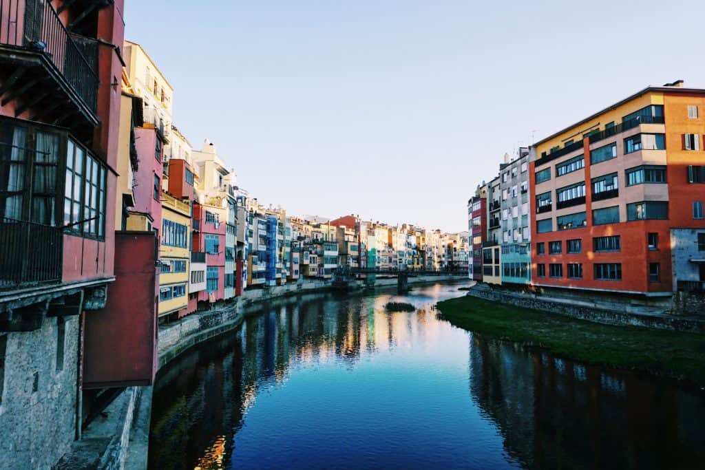 1. Walk across the Eiffel Bridge Girona's jewel is the Eiffel bridge, which although it was designed by the same Gustave Eiffel as Paris' Eiffel Tower, with a similar aesthetic, is understated just like the rest of the city. TripAdvisor seems to bash it for its humble appearance, but I loved the Eiffel Bridge's simplicity. As you walk across, make sure you get a quintessential photo looking at the colorful houses along the river Onyar through the bridge's steel work!