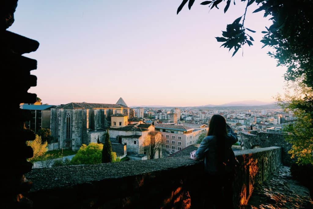 4. Walk the Medieval Walls / Passeig de la Muralla (and Find the Toilet!) Girona was once a walled city, and now you can walk along the top of the remains of the medieval walls! The walls also host the very best view of the city, including the mountains beyond. We strolled along at sunset which was gorgeous. If you're a weirdo like us - try to find the "toilet" along the far wall. It looks like a corner bench, but has a circular hole in it that you can see all the way down (hundreds of feet...) to the ground. Apparently this served as a 9th century toilet for the wall's guards?!