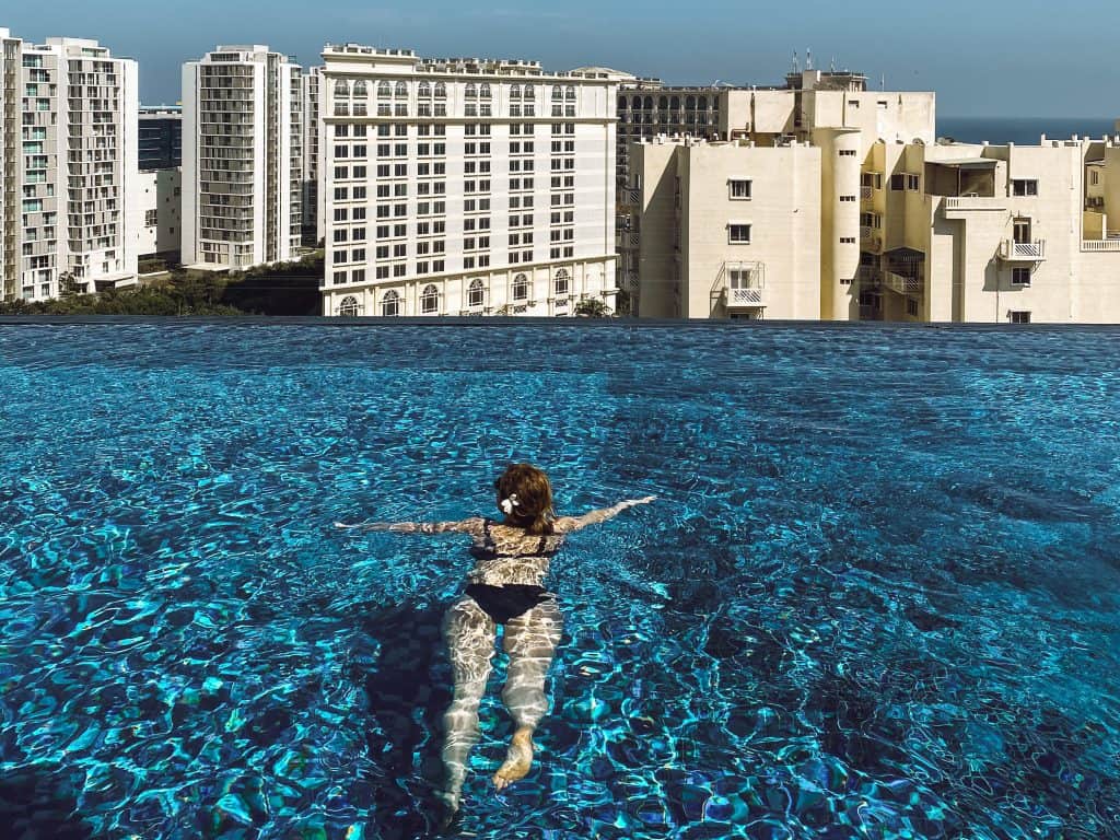 Swimming at the rooftop infinity pool at Somerset Greenways in Chennai India.