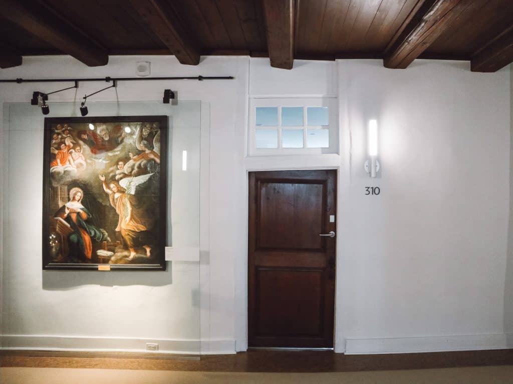 Hallway with wooden door and painting