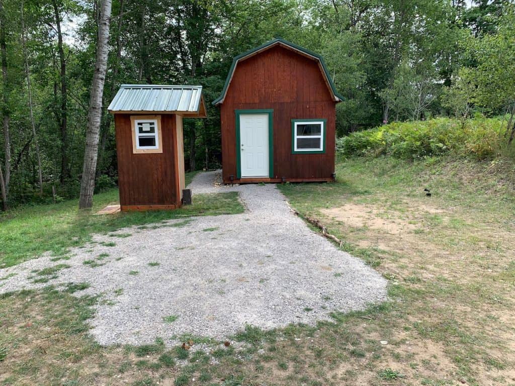 a small barn and outhouse