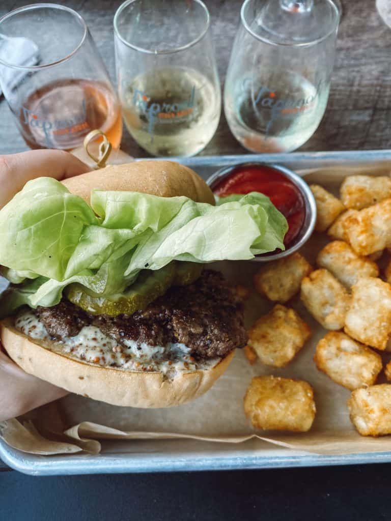 Gluten free burger bun, cider flight, and tater tots cooked in a dedicated gluten free fryer in Traverse City, Michigan.