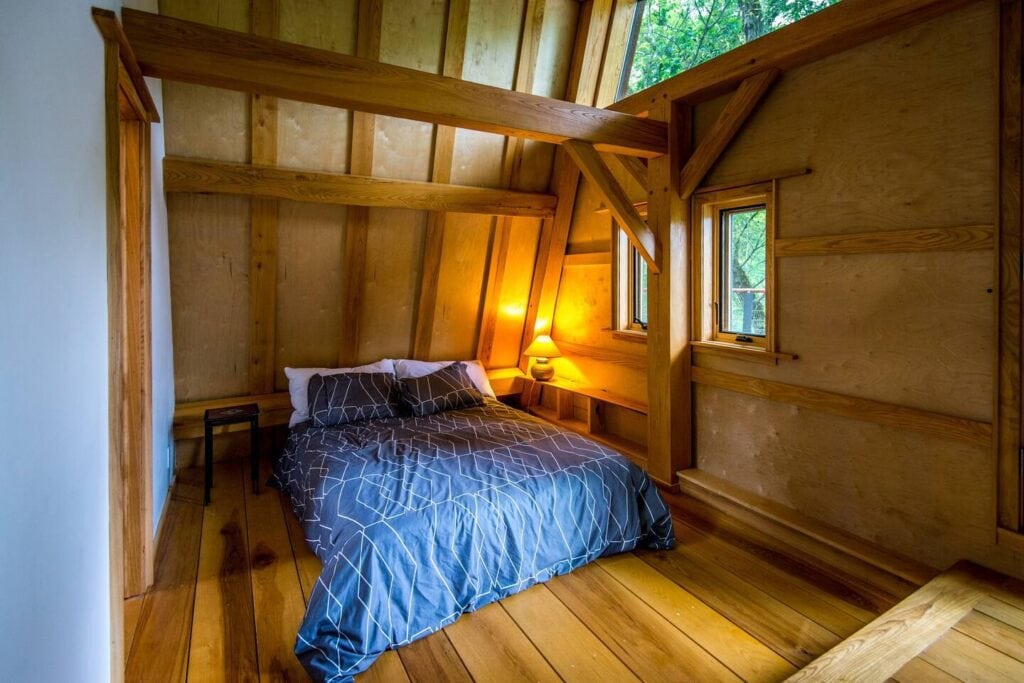 Master bedroom within a Timberframe romantic cabin.