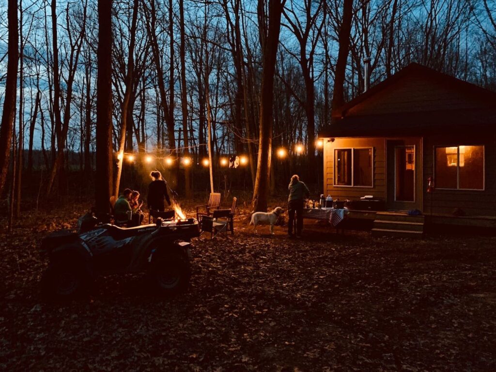 Michigan evening outside the cabin illuminated by hanging lights.