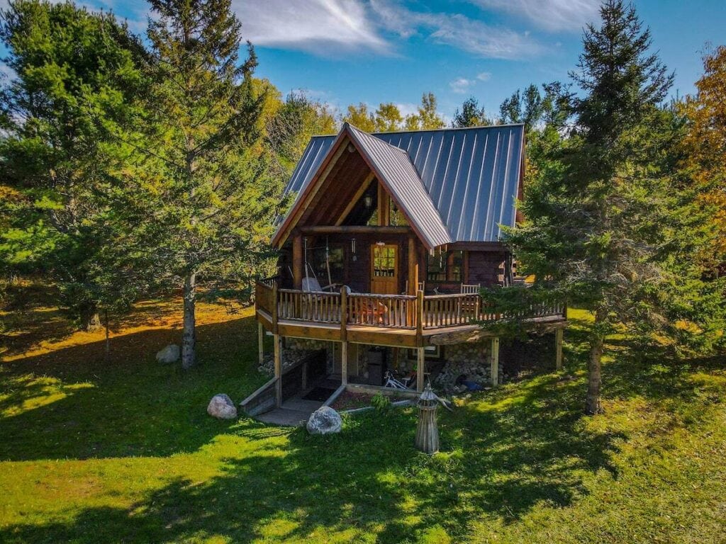 Romantic Michigan cabin surrounded by trees.