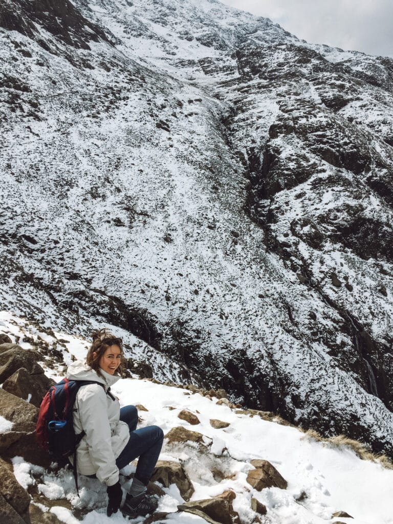 Sarah sitting on the edge at Scaffel Pike - Keswick walks