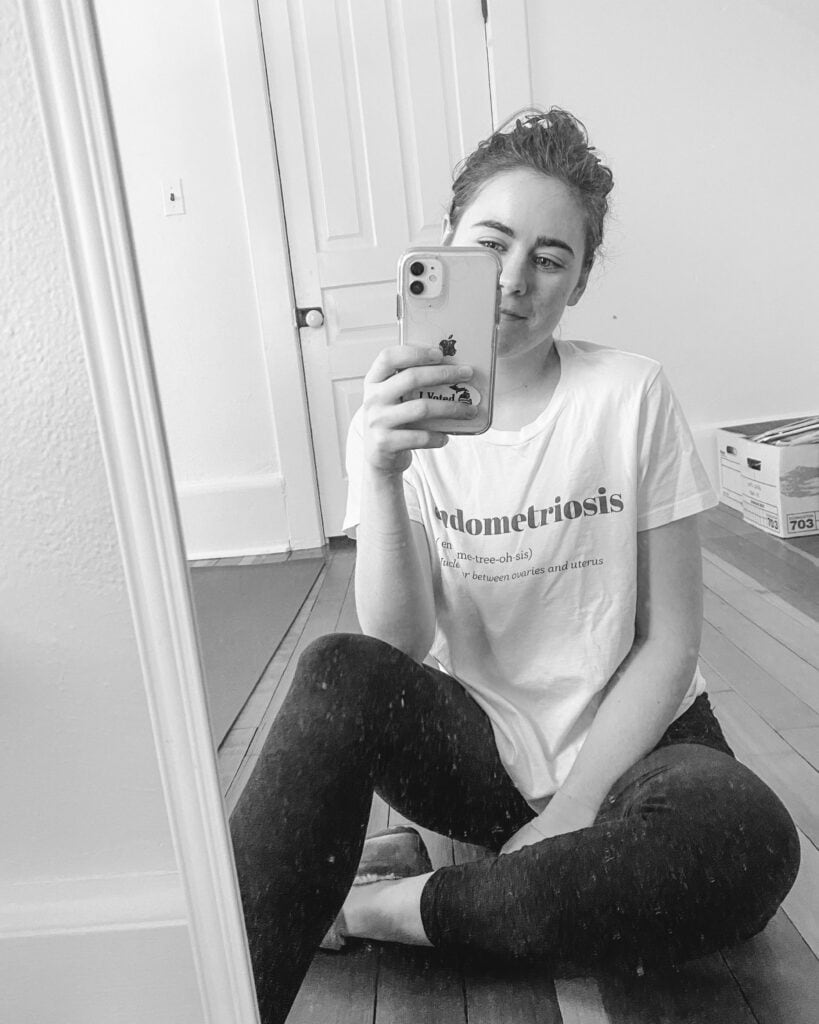 my journey with endometriosis, sarah sitting in front of mirror in endo shirt in black and white