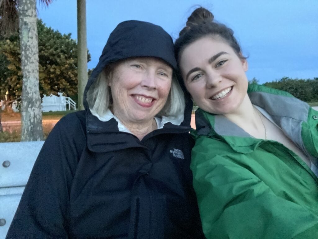 how to see nesting sea turtles in florida - sarah and her mom wearing rain coats in the evening getting ready for their turtle walk