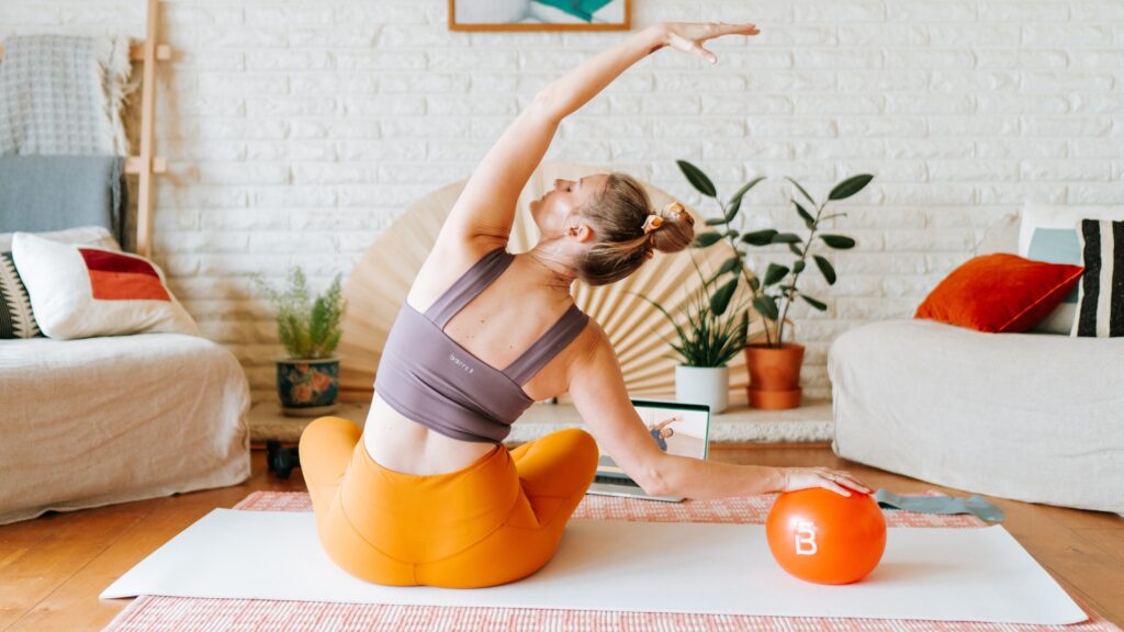 woman with core ball doing barre3 stretches