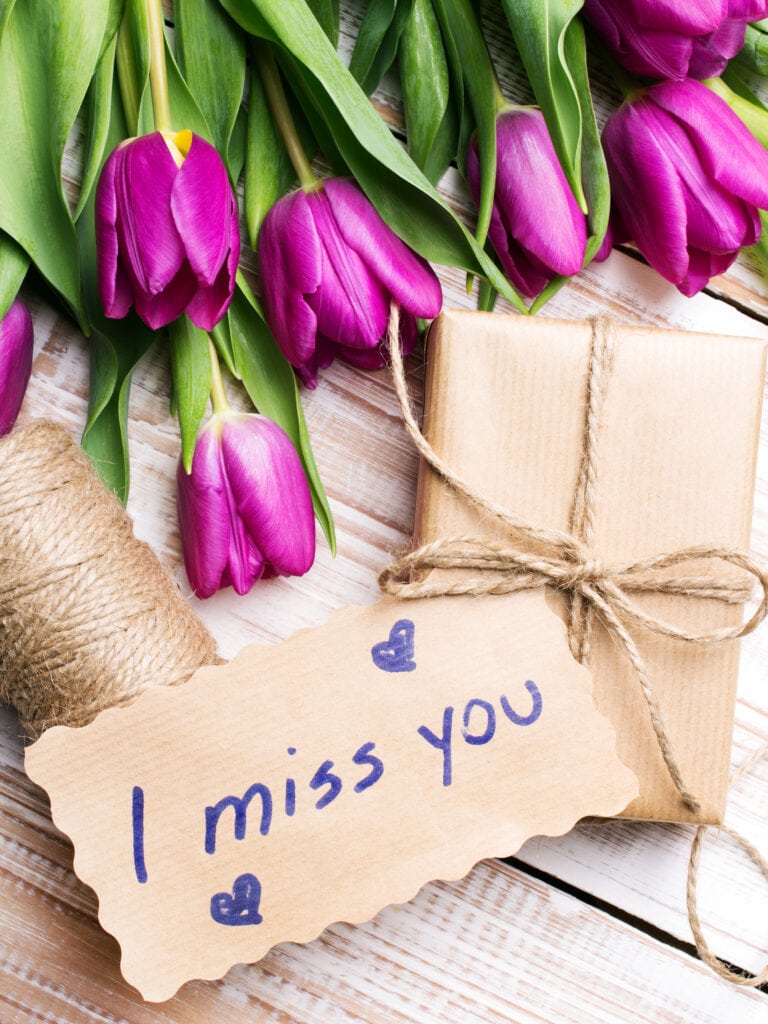long distance relationship gift ideas - i miss you card with a present and red tulips