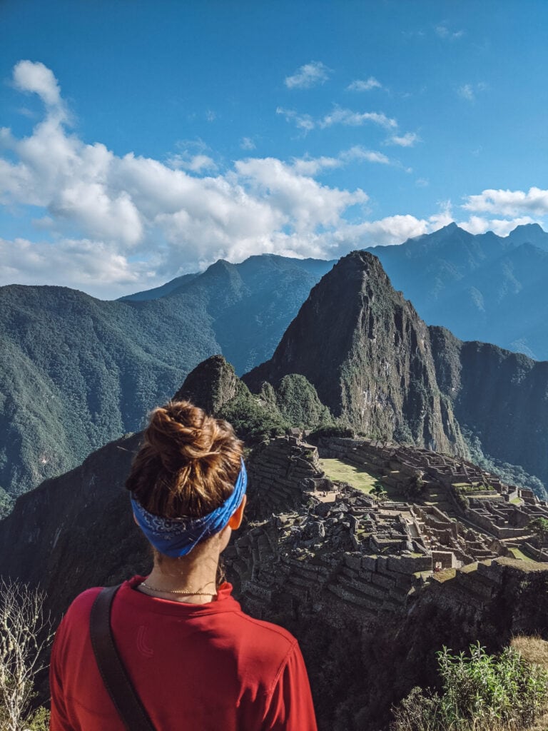 Sarah posing with Machu Picchu in the distance, the last stop on the salkantay trek