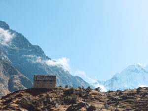 A small house sits in the Peruvian mountains, one of the best salkantay trek photos