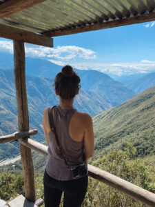 Sarah looking out over the green and blue mountains along the salkantay trek