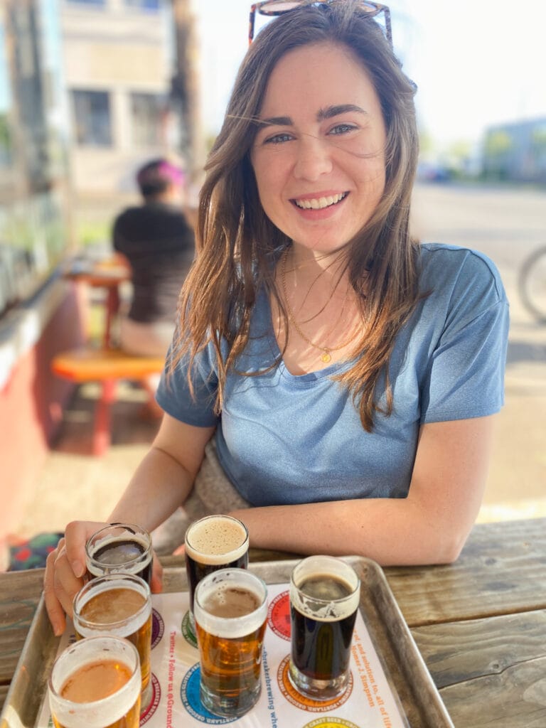 sarah with flight of gluten free beer in portland oregon