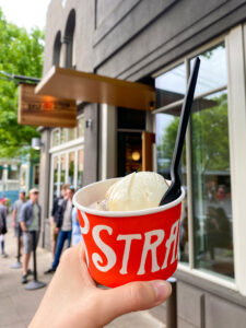 red salt and straw ice cream cup with the shop in the background
