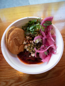 bowl of arepas and pink pickled onions and pork from teote in portland oregon