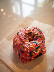gluten free donut pink frosting with sprinkles