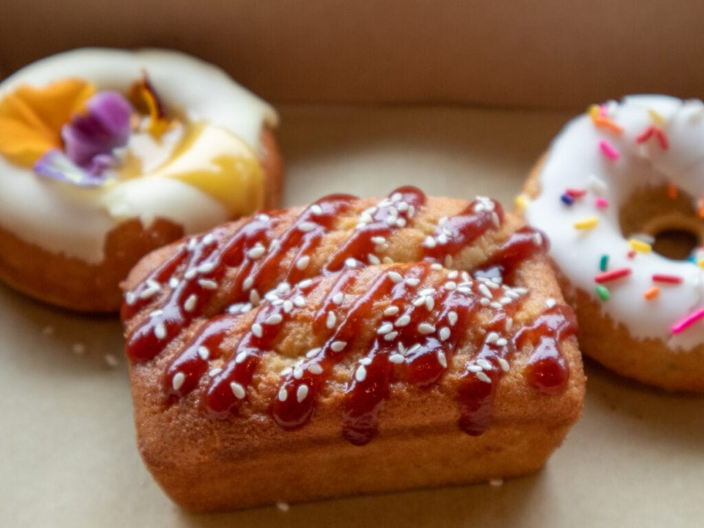 gluten free mochi hot dog with gluten free donuts in the background in portland oregon