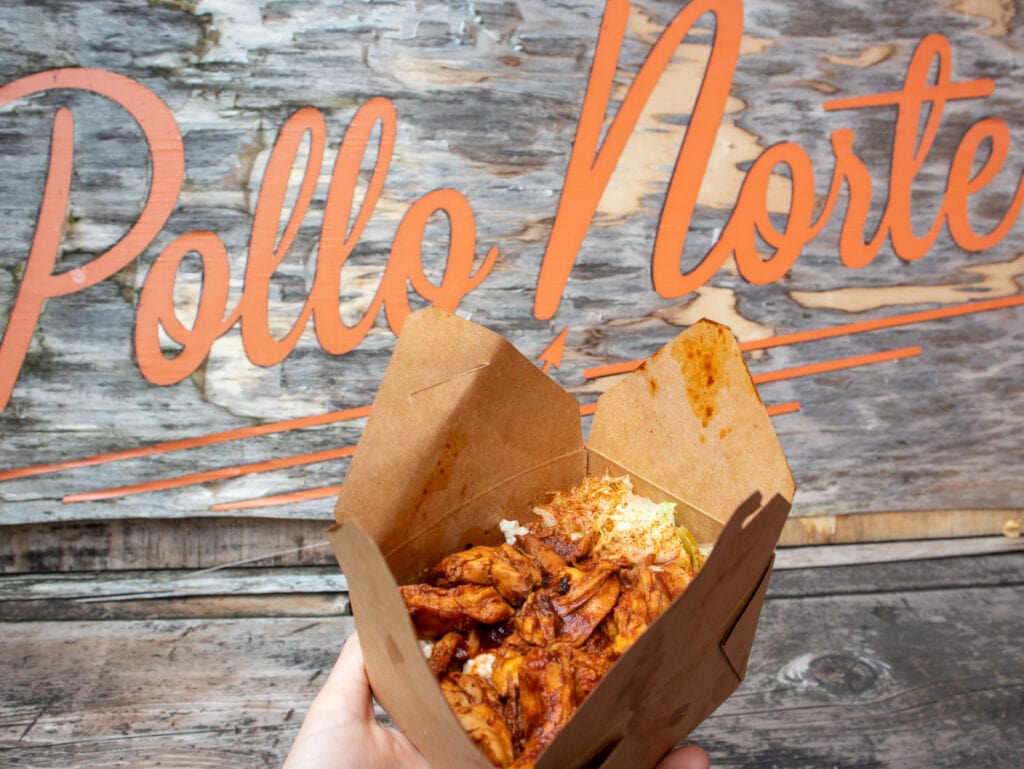 gluten free pulled chicken in a box with pollo norte written in orange in the background