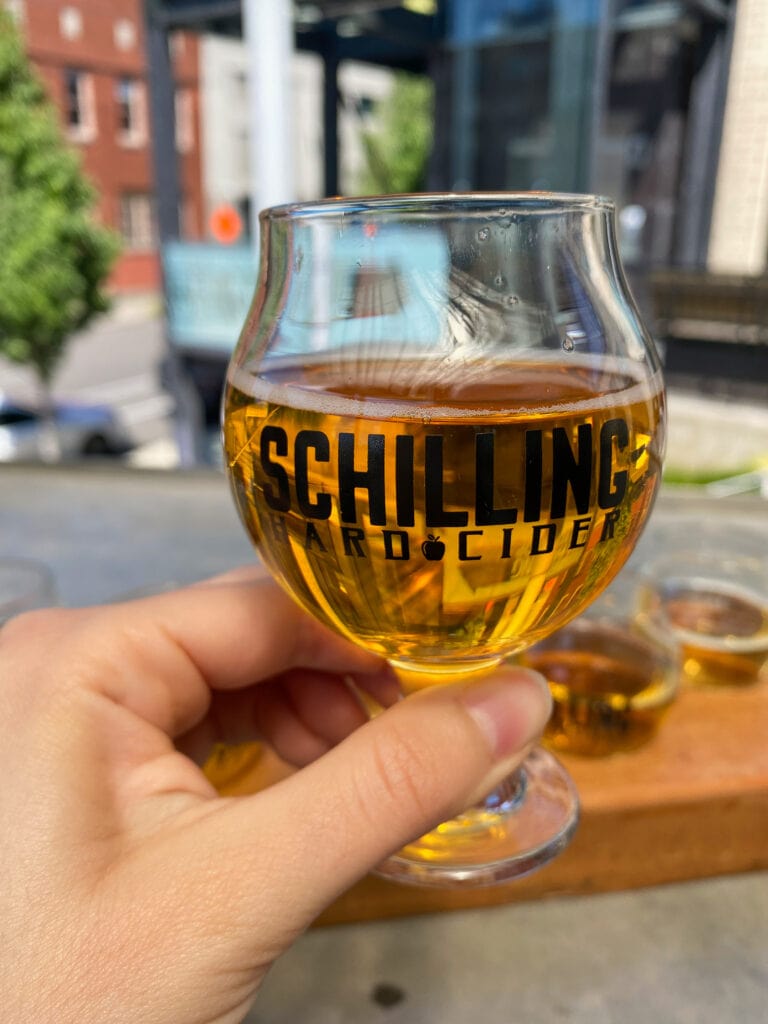 glass of gluten free cider that says schilling cider in black text