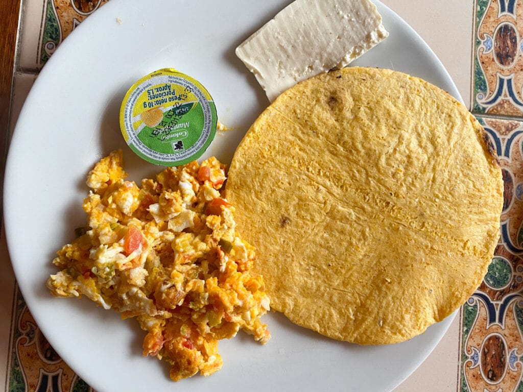 Arepa, scrambled eggs and vegetables, and natural cheese at Hostal La Comedia in Jardin Colombia.
