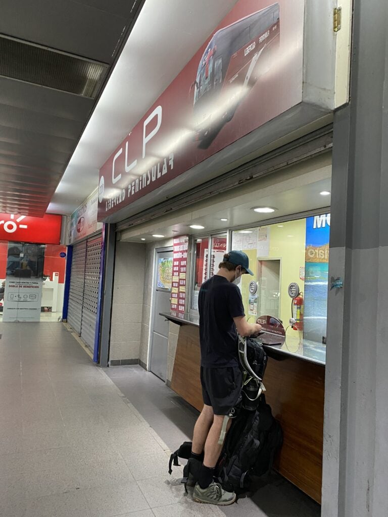 Dan booking bus tickets at the terminal in Guayaquil Ecuador.