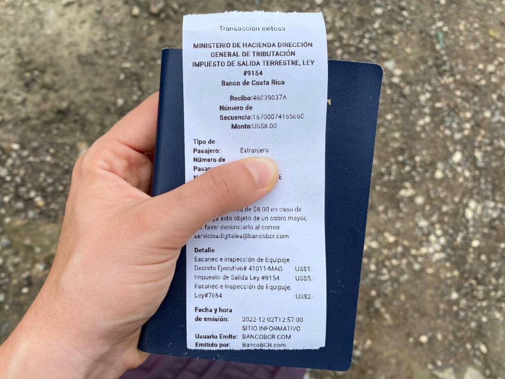 A white receipt and blue passport.