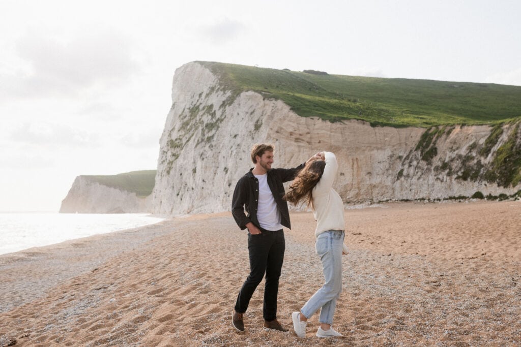 Long distance relationship couple twirls on beach