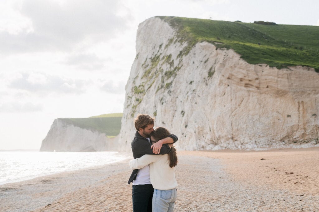 Long distance relationship couple hug on the beach
