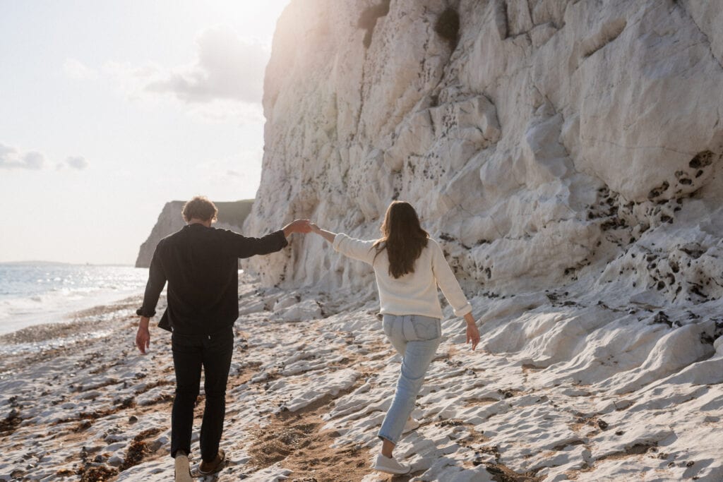 Sarah and Dan walk on beach