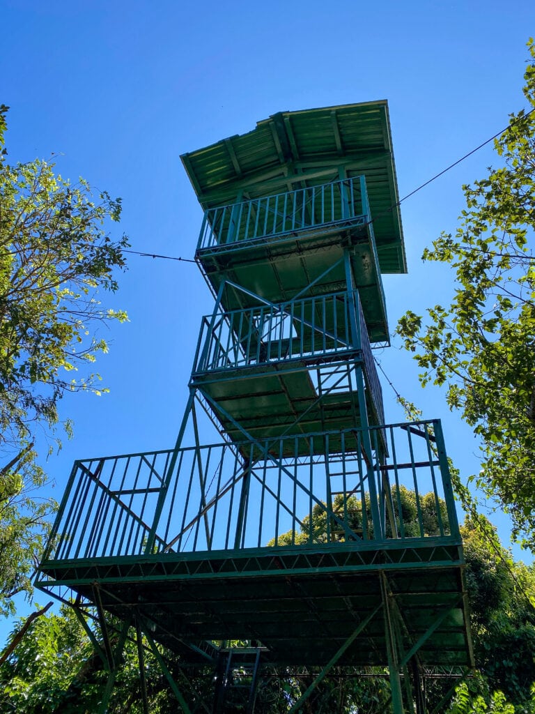 A tall blue-green watch tower.