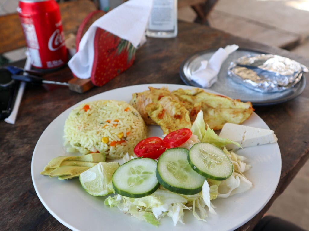 A chicken, rice, and salad dish.