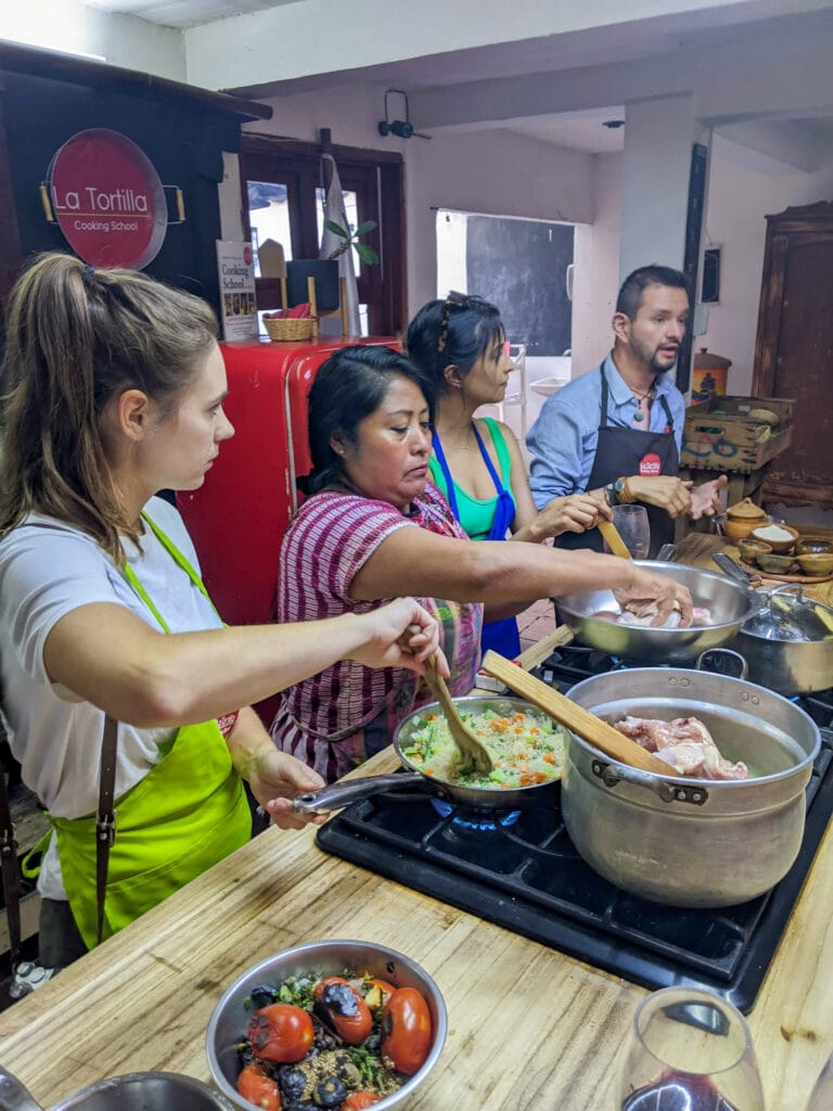 People stirring pots on a stove.