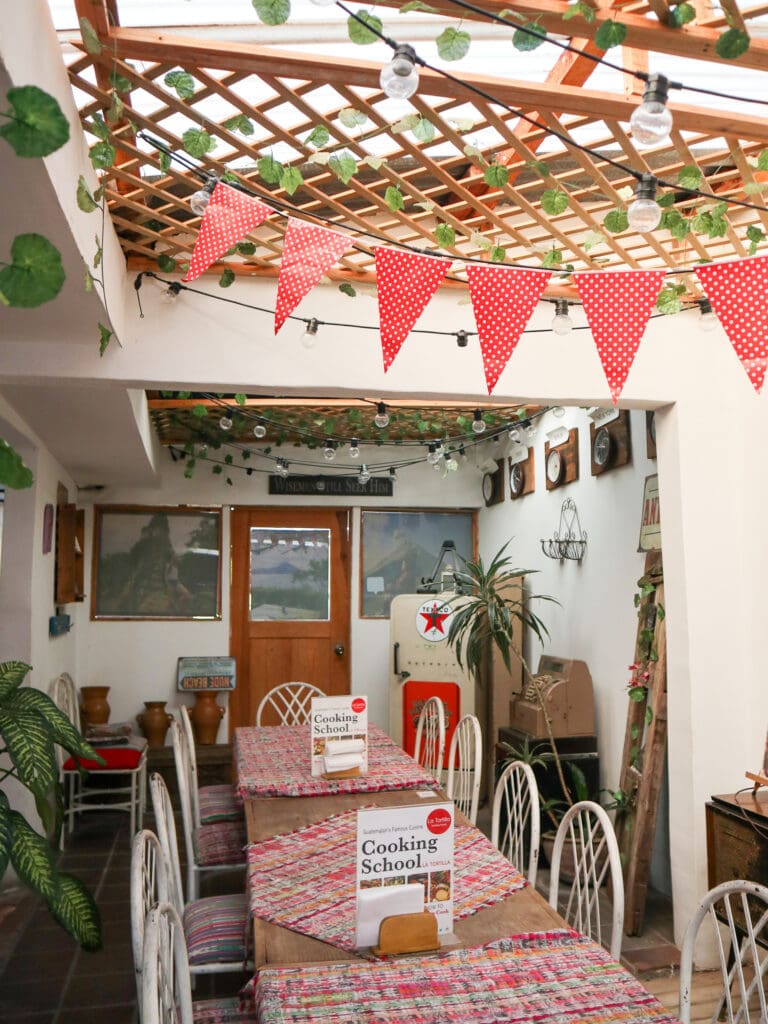 A long wooden table with red bunting banner handing above it in a light, airy space.