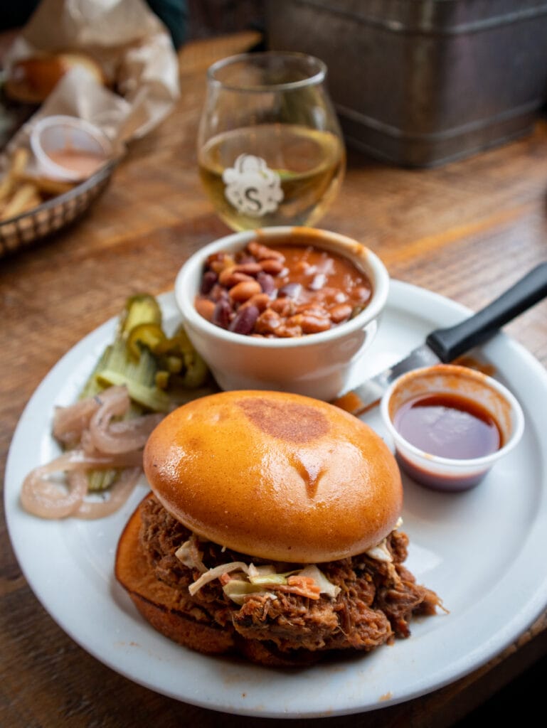 A pulled pork sandwich on a gluten free bun in Cannon Beach Oregon.