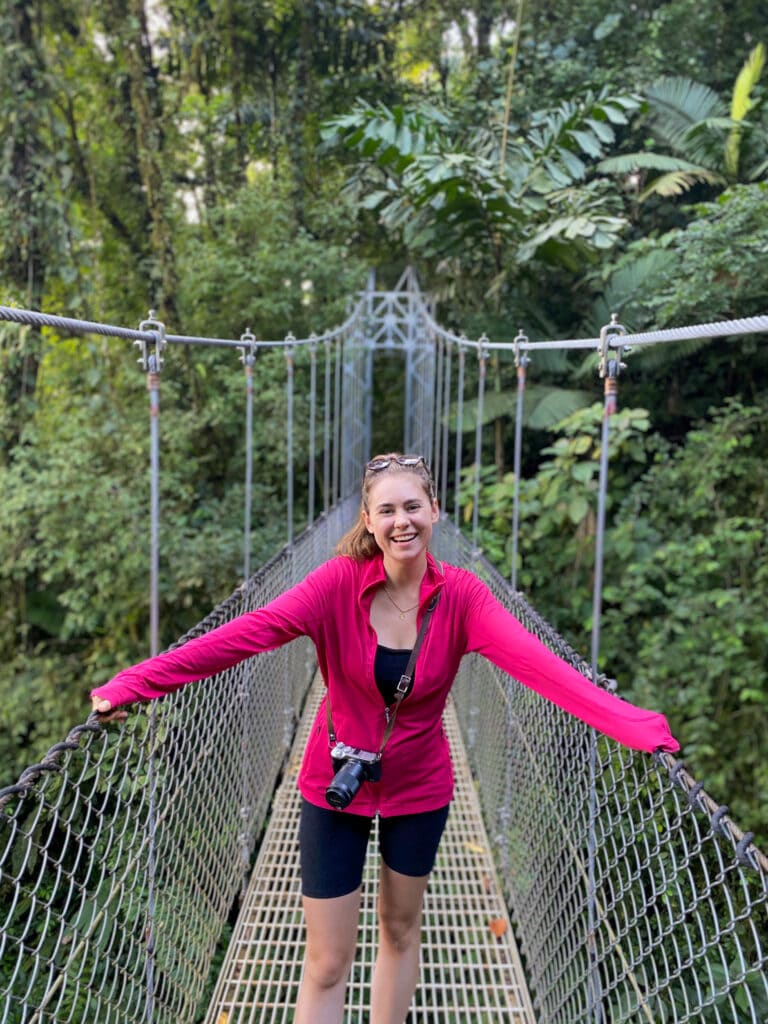 sarah smiling on a hanging bridge