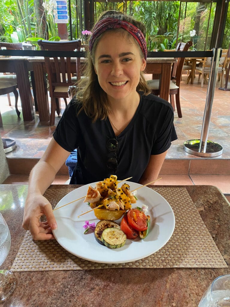 sarah smiling with gluten free chicken kabobs in costa rica