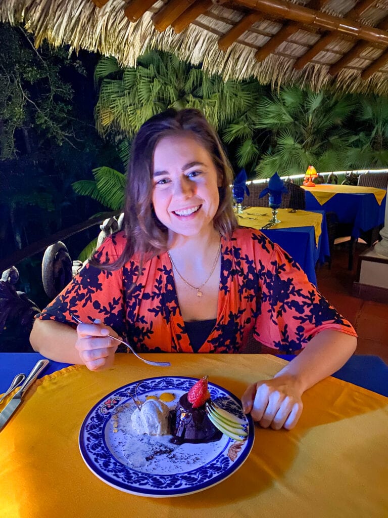 sarah smiling with gluten free chocolate lava cake at a 100% gluten free hotel in costa rica