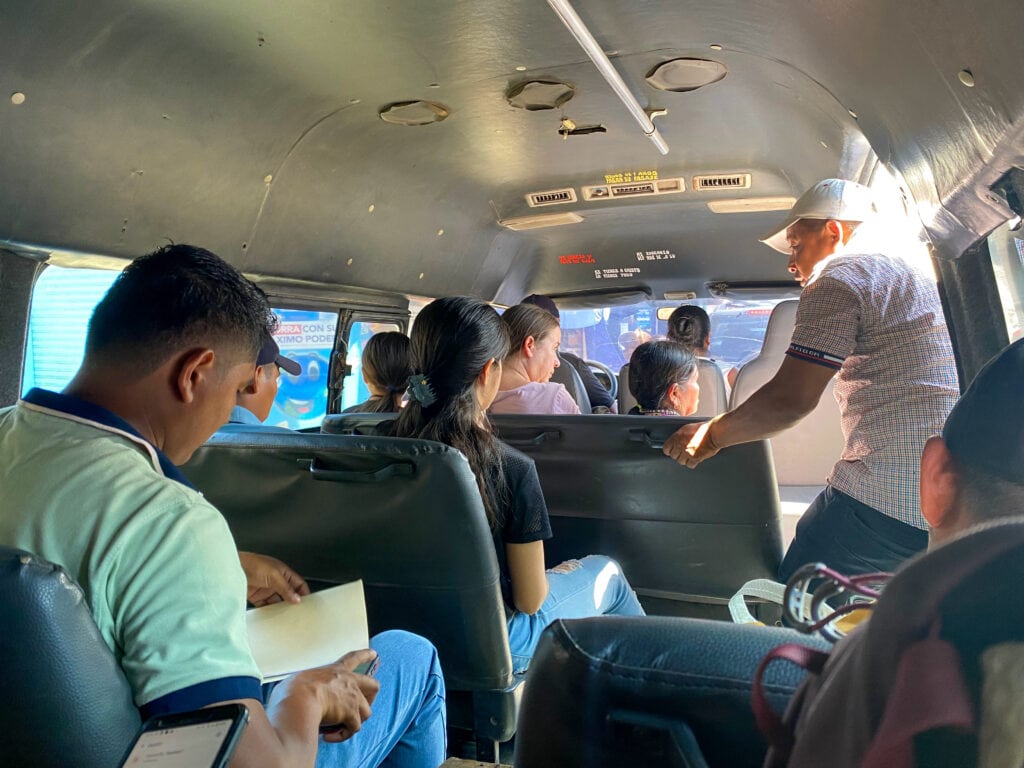 The inside of a van with Guatemalans sitting inside.