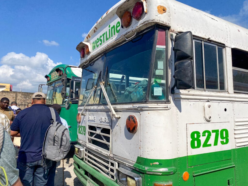 A green and white chicken bus in Belize.