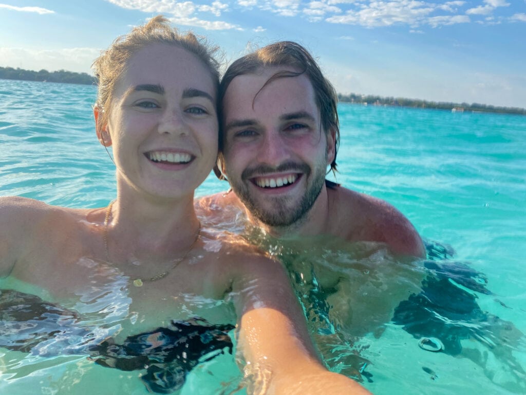 Selfie of Sarah and Dan swimming in Lake Bacalar in Mexico.