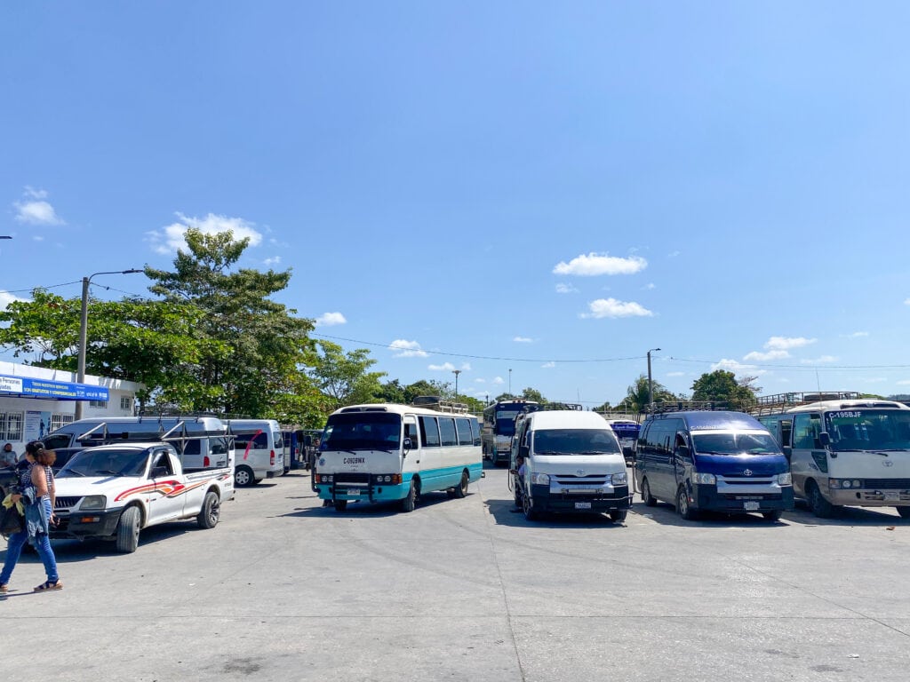 A row of vans at the Fuente del Norte bus station in Flores Guatemala.