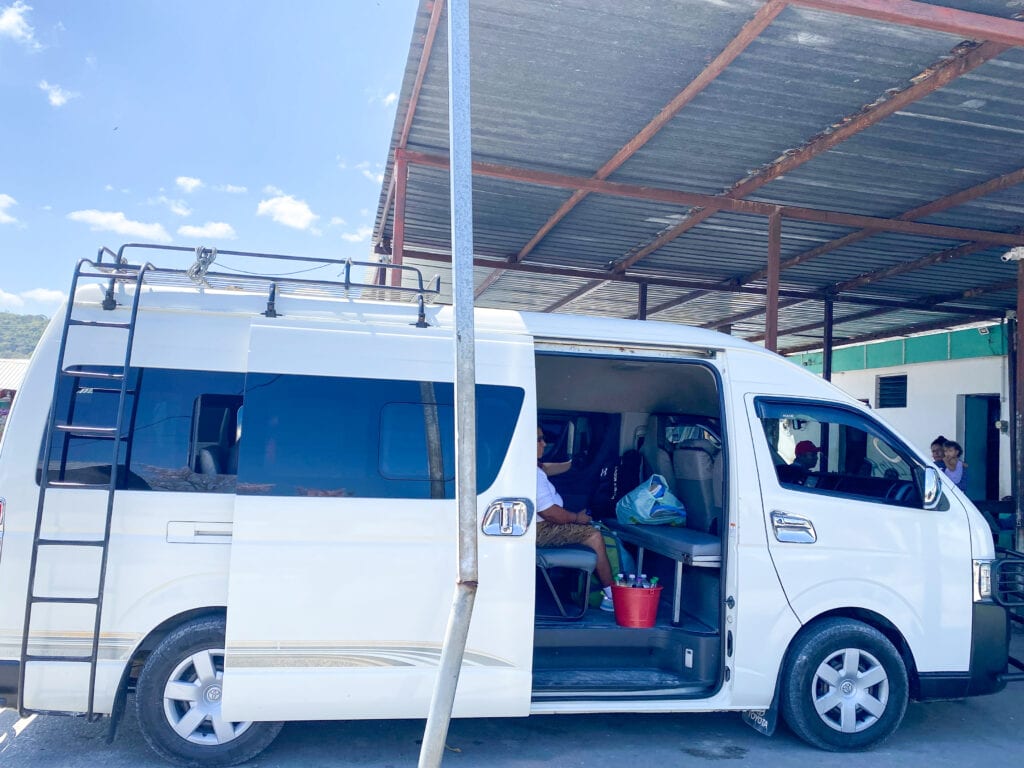 A white van with the side door half open.