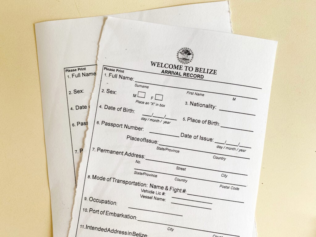 A white paper form that says "welcome to belize arrival record". 