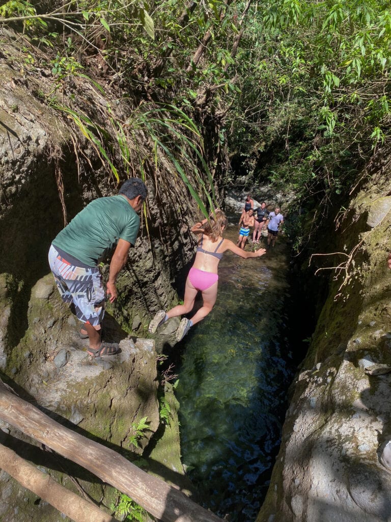 Sarah cliff jumps into a green pool.