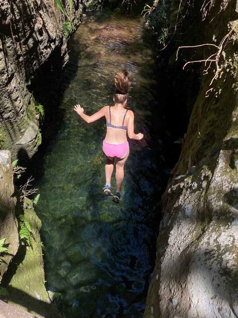 Sarah cliff jumping in El Salvador in El Impossible National Park.