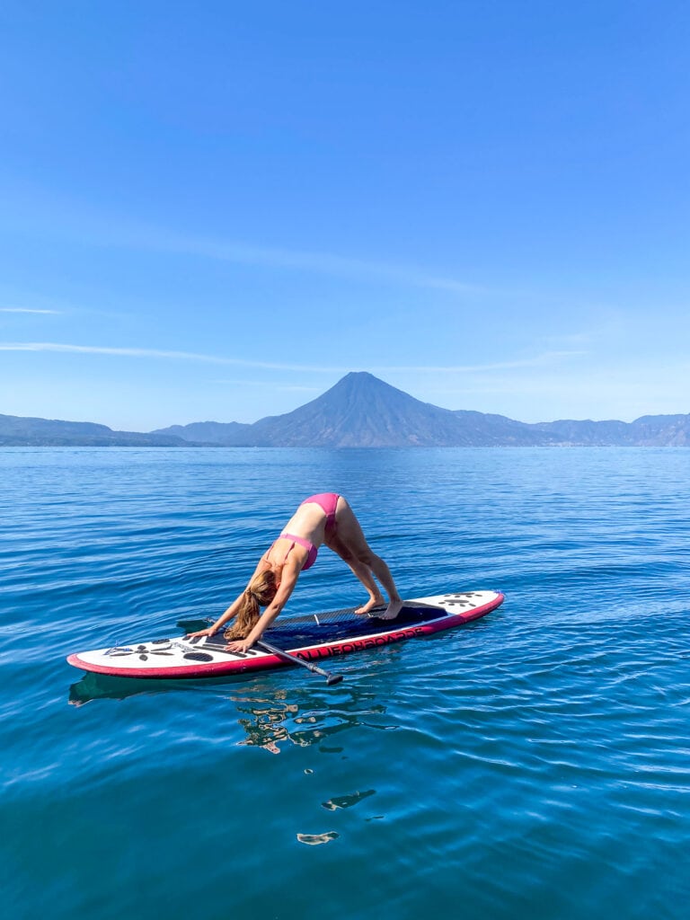 Sarah does downward dog SUP yoga on Lake Atitlan.