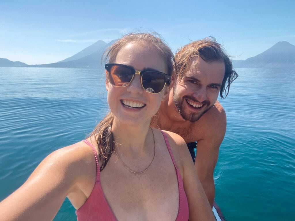 Selfie of Sarah and Dan sitting on paddle board in Lake Atitlan.